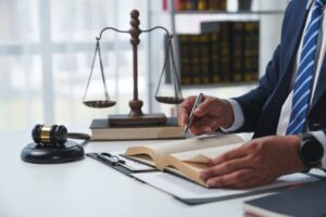 Lawyer and businessman reviewing agreement details and contract documents for accuracy, focusing on joint financial investment and legal processing.