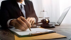 Male judge in a courtroom on a wooden table, with a male lawyer working in an office. Represents justice, legal advice, and the legal system.