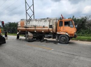 Tanker truck involved in a highway accident during the day.