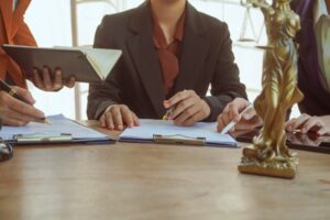 Lawyers and clients in a professional meeting at a law office, discussing agreements, contracts, and legal matters, focused on justice and expert advice.