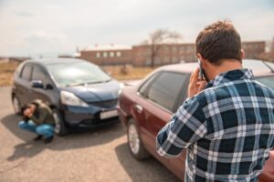 Driver calling the police after a car accident.