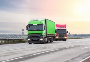 Trucks driving on the Phoenix highway at sunrise.