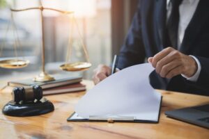 Lawyer reviewing business and life insurance contracts, and a businessman signing documents to secure a loan for a new business venture.