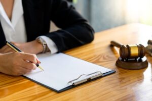 Businesswoman lawyer and notary signing documents in an office. Concept of legal consultation, justice, and court proceedings.