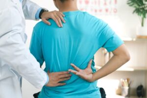 Physiotherapists treat lower back pain in patients at the hospital, focusing on back injuries and muscle recovery through physical therapy.