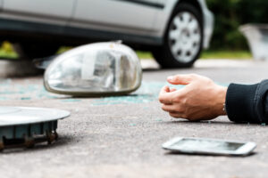 Close-up of hand of a careless driver involved in an incident after using a phone while driving 