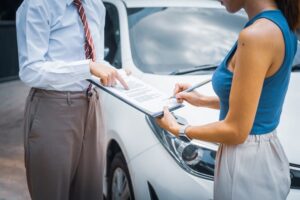 Young businesswoman reviews car insurance options, assessing coverage for medical expenses, property damage, and lost income claims.