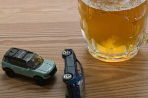 Image of a drunk driving accident with a beer mug 